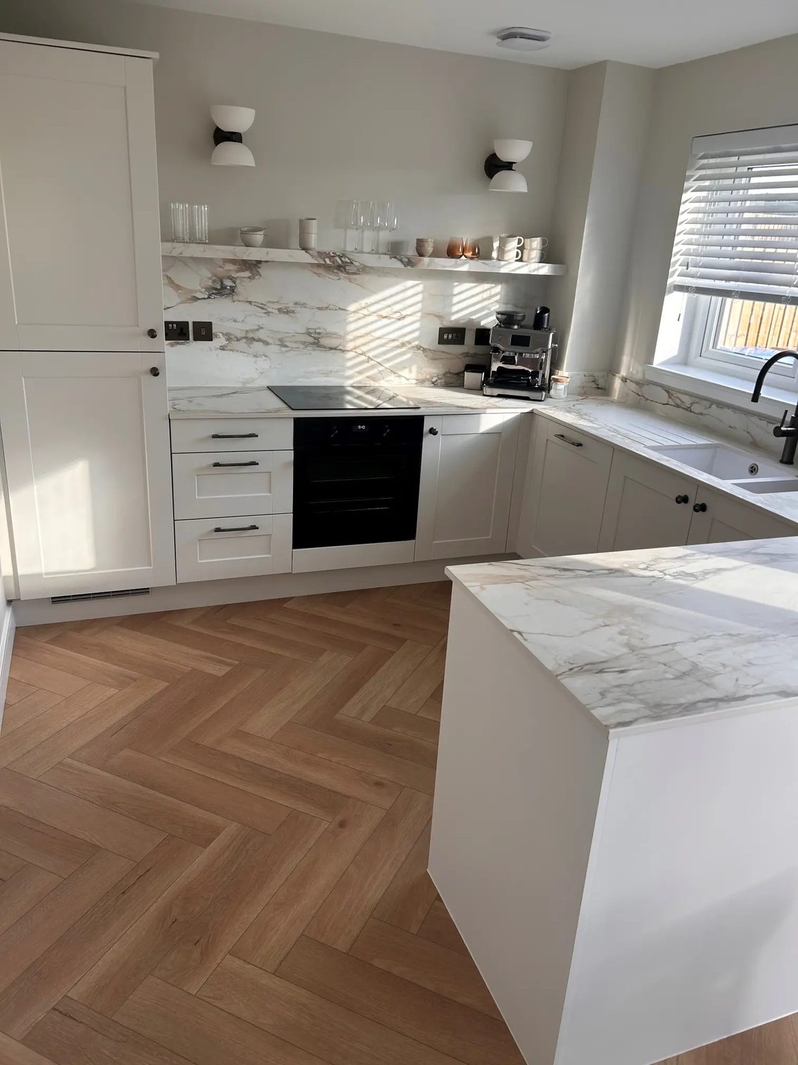 Marmo Antico porcelain peninsula and worktop run in a bright West Lothian kitchen