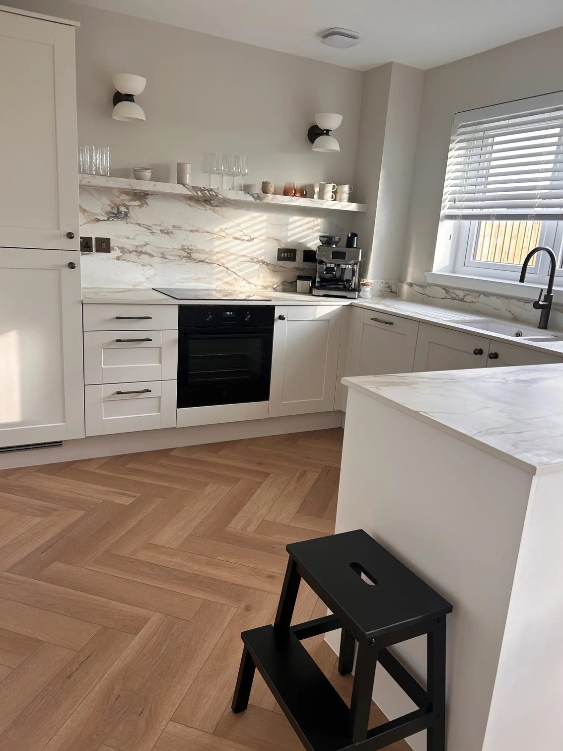 Finished porcelain kitchen with peninsula, backsplash and floating shelf